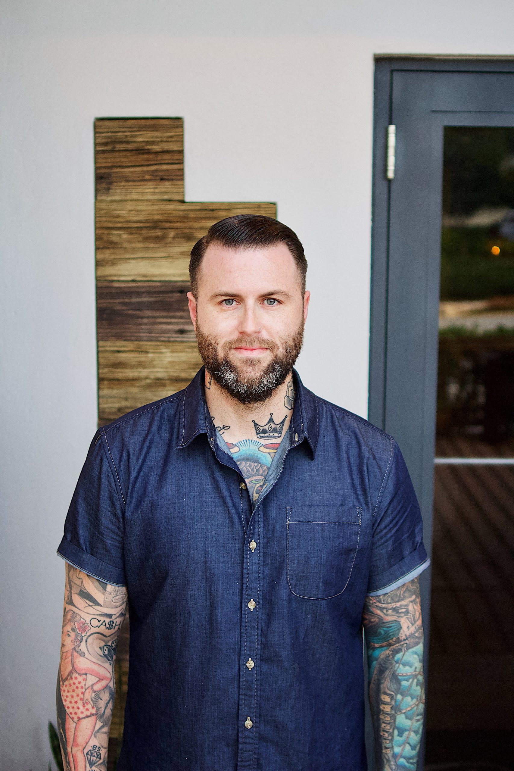 Photo portrait of Bar director and partner Freddy Schwenk standing in front of restaurant